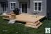 Low, single level deck with a bench and planters.