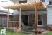 Medium size, low, single level deck design with planters and a pergola.