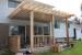 Medium size, low, single level deck design with planters and a pergola.
