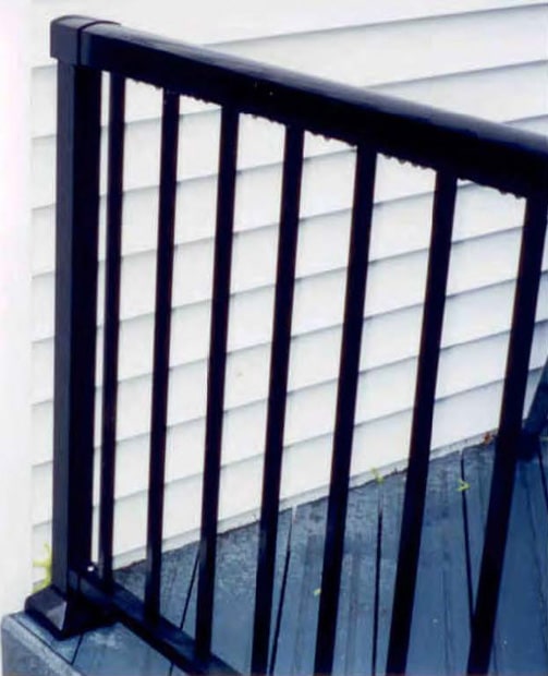 Aluminum railing end post next to the house.