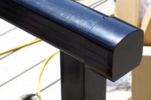 End cap on top rail of aluminum deck railing.