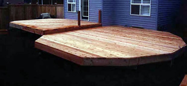 New two-level deck with wood deck boards installed.