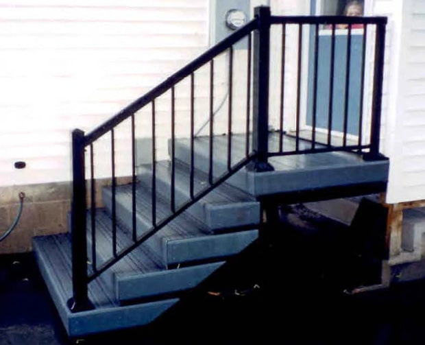 Aluminum railing on steps to a side door.
