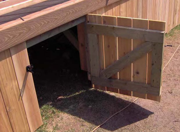 An open gate in a deck skirt showing gate construction detail.